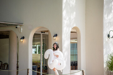 Happy 28th Birthday to a beautiful Asian woman. She is happy and smiling in a park, green nature...