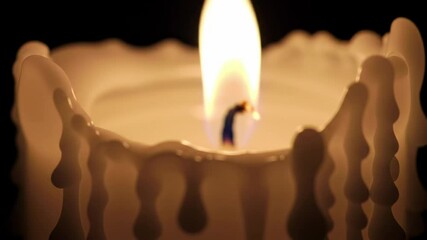 Close up of a white candle flame burning in darkness. Warm intimate light with melting wax for calm, relaxation, and remembrance footage. - Powered by Adobe