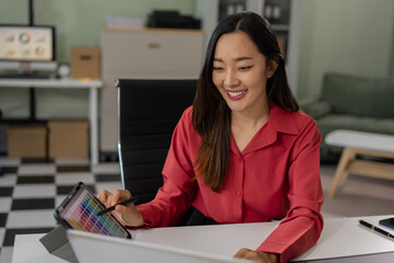 Female coder or developer working using a computer display in problem solving at workplace.