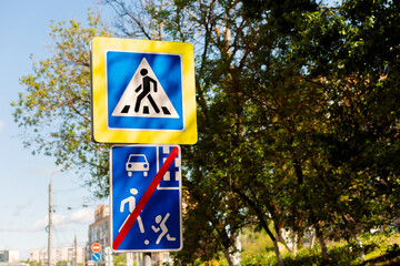 The sign warns of a pedestrian crossing, prohibits stopping and parking of vehicles, and also...