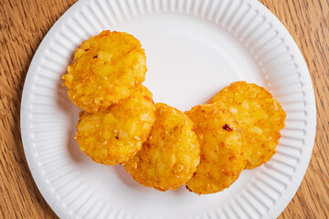 Deliciously crunchy potato bites arranged neatly on a white paper plate during a fun event