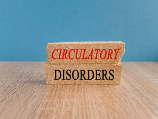 Brick blocks with word Circulatory Disorders on beautiful wooden table blue background. Medicine...