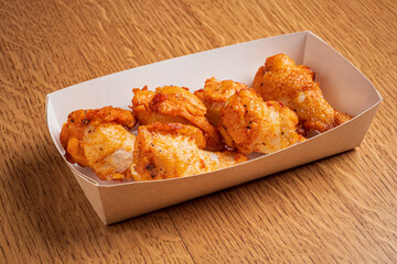 Crispy fried chicken pieces are artfully arranged, tempting with their savory aroma and texture