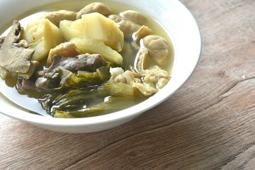 boiled pickled cabbage with pork innard in clear soup on bowl 
