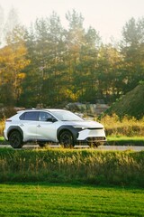SUV on a country road in sunlight