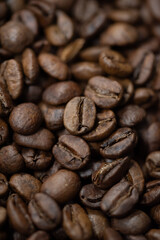 Dark roasted coffee beans close up texture. 