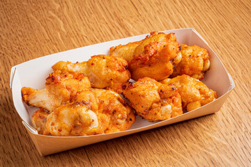 Golden brown chicken wings await hungry diners, showcasing a delicious crunch and flavor