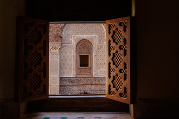 Courtyard views of Al Attarine Madrasa, a 14th-century school for Islamic studies featuring ornate tile work & dramatic architecture, in the old town Medina of Fez el Bali, Fez, Morocco