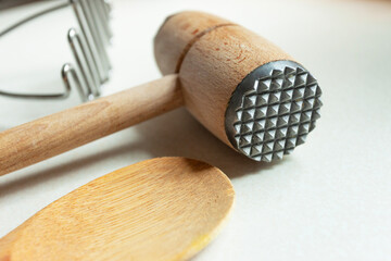 Meat tenderizer with wooden spoon and potato masher
