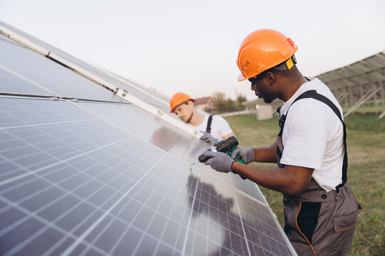 Technicians Installing Solar Panels on a Sunny Day
