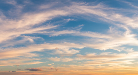 Fototapeta premium Dramatic clouds painted with soft colors during twilight sky create a dreamy atmosphere