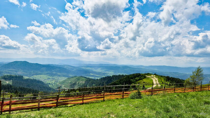 Carpathian landscape with wooden fence and blue sky