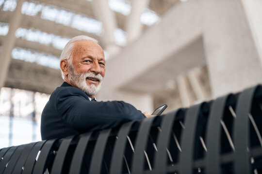 Mature Businessman Smiling in a Modern Architectural Setting