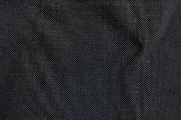 Fabric composed of wool and polyester, macro texture, abstract black fabric background.