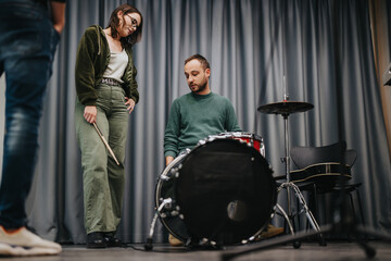 Band members rehearsing music together in a studio with instruments