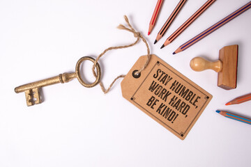 Stay Humble, Work Hard, Be Kind. Motivational Message Tag with Vintage Key and Colored Pencils on...