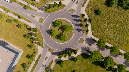 A street view of a roundabout with trees and grass. Aerial view.