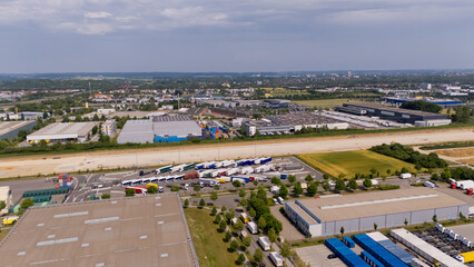 A large industrial area with many trucks and buildings. Aerial view.