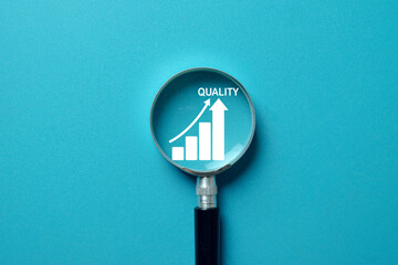 Magnifying glass focus on a quality improvement chart.Concept for quality management,assurance...