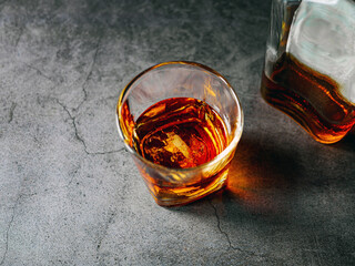 Strong alcohol drink and whiskey bottle Whisky in glass with ice, Whisky, bourbon or cognac. Hard...