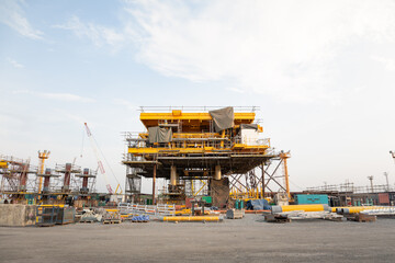 Oil rig under construction onshore. To assemble steel structure platform by lifting , technology engineering. Heavy industry for exploration and drilling for crude oil resources and natural gas.
