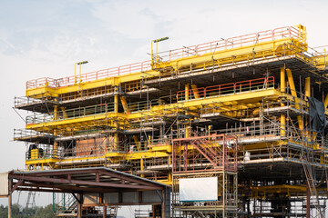 Oil rig under construction onshore. Heavy industry for exploration and drilling for crude oil resources and natural gas. Project from investment in energy and gas business.