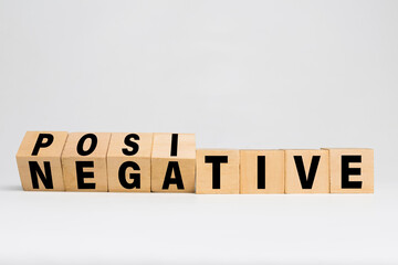 flip wooden blocks with positive and negative words isolated on white background