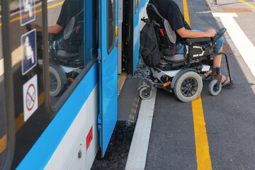 Man with disability uses a wheelchair to board a train.