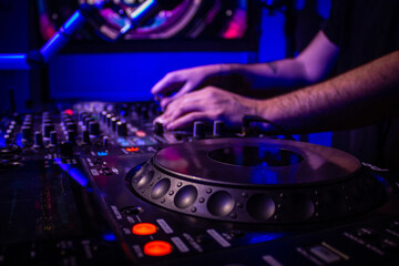 Obraz premium Dj mixes the track in nightclub at party