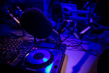 Dj mixes the track in nightclub at party