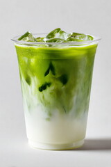 a transparent plastic cup filled with iced matcha latte 