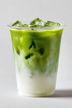 a transparent plastic cup filled with iced matcha latte 