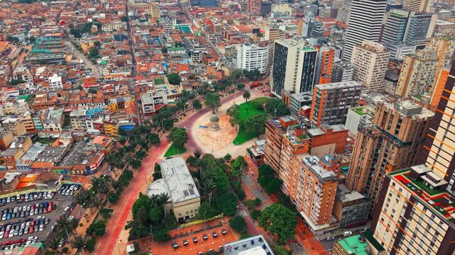Aerial orbit establishing the contrast of the city of Bogota, Colombia at the Gabriel Garc&iacute;a Marquez journalists' square, on a sunny day, La Candelaria neighborhood.