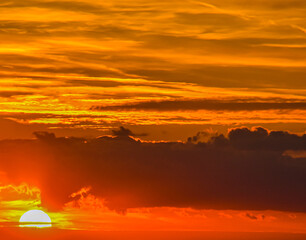 Dramatic sunset sky filled with vibrant orange and yellow tones
