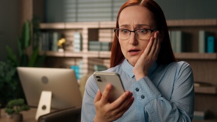 Stressed woman Caucasian girl upset frustrated businesswoman worker office holding mobile phone...