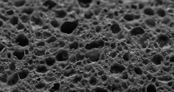 Seamless Rotating Sponge Texture Loop. Video featuring a smooth, rotating pattern of a sponge texture with organic pores, ideal for dynamic design projects.
