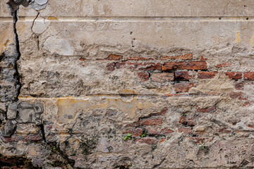 Damaged Old Brick Wall with Eroded Plaster