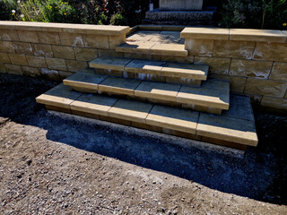 Retaining wall at the monument. Foil insulates the damp soil. Staircase in the shape of a pagoda...