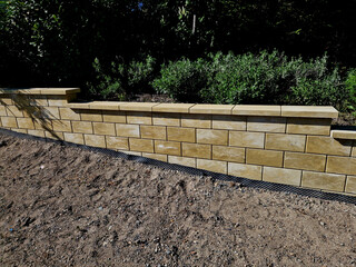 Retaining wall at the monument. Foil insulates the damp soil. Staircase in the shape of a pagoda...