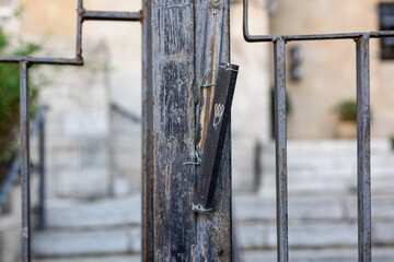 A mezuzah affixed to the metal gate of a home in Jerusalem, Israel.