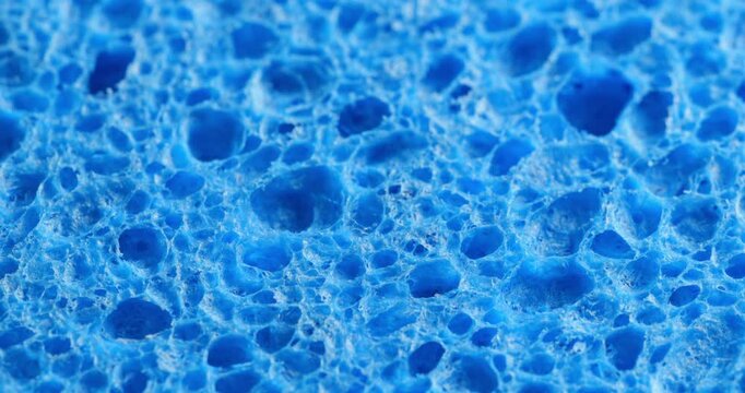 Seamless Rotating Blue Sponge Texture Loop. Video featuring a smooth, rotating pattern of a vibrant green sponge texture with organic pores, ideal for dynamic design projects.