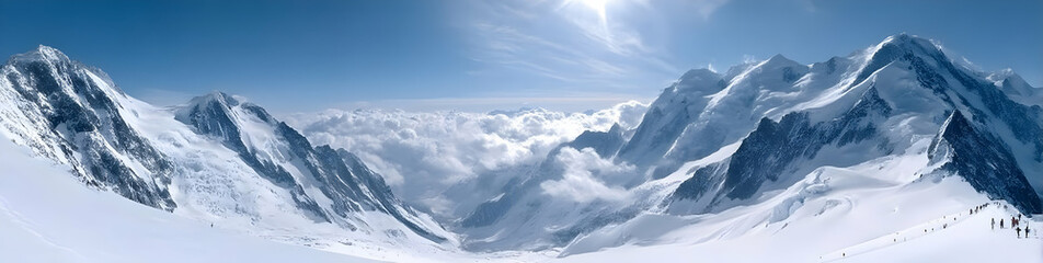 Obraz premium A breathtaking panoramic view of snow-capped mountains under a clear blue sky, showcasing nature's beauty.