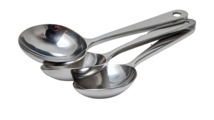 Set of three shiny metal measuring spoons isolated on transparent background