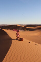 Beautiful woman in the dunes of the desert