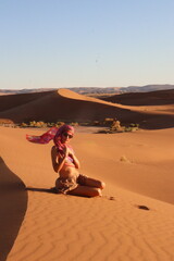 Beautiful woman in the dunes of the desert