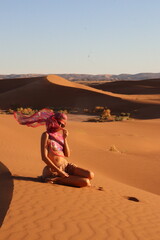 Beautiful woman in the dunes of the desert