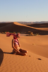 Beautiful woman in the dunes of the desert
