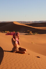 Beautiful woman in the dunes of the desert
