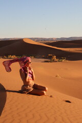 Beautiful woman in the dunes of the desert