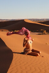 Beautiful woman in the dunes of the desert